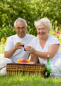 hearing elderly couple enjoying a picnic