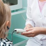 clinician assessing child hearing